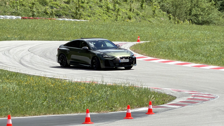A green 2027 Audi RS5 drifting on track