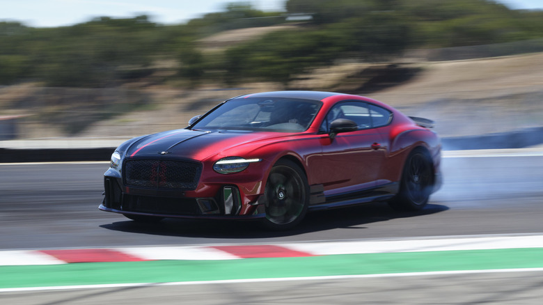 Front 3/4 view of a red and black Bentley Supersports drifting