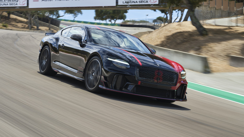 Front 3/4 view of a red and black 2027 Bentley Supersports