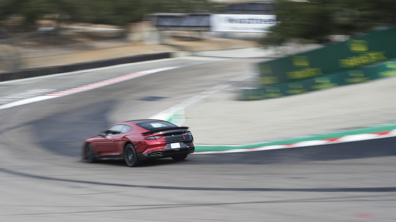 A red and black 2027 Bentley Supersports driving down the Corkscrew