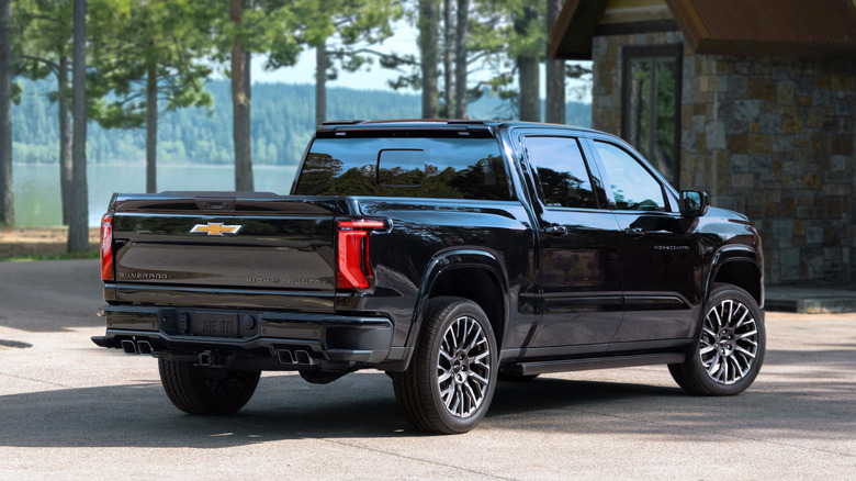 Rear 3/4 view of a black 2027 Chevrolet SIlverado 1500 High Country