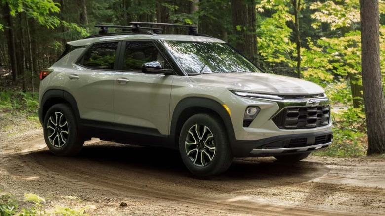 Front three-quarters shot of a Gray Trailblazer Z71 parked on a dirt road in a wooded area
