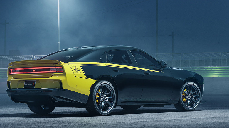 rear three-quarters shot of a Charger four-door painted black with yellow graphics encompassing the rear of the car and a stripe on the belt line that stretches to the wing mirrors