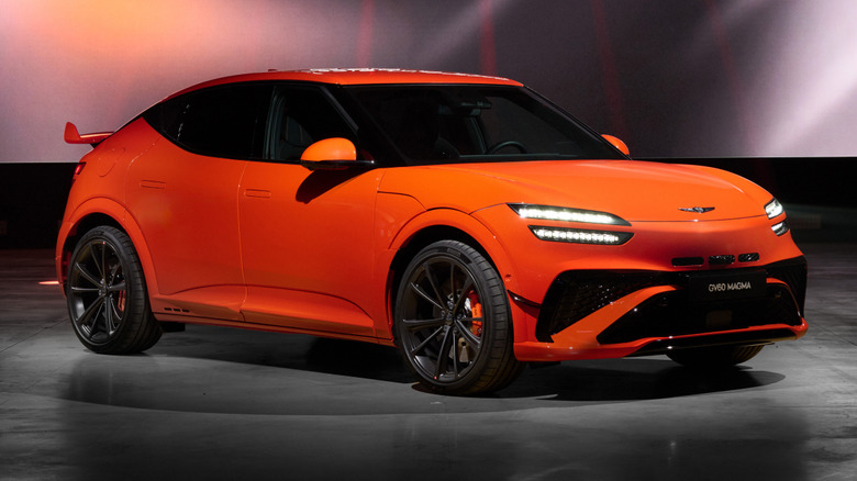 Front 3/4 view of an orange Genesis GV60 Magma