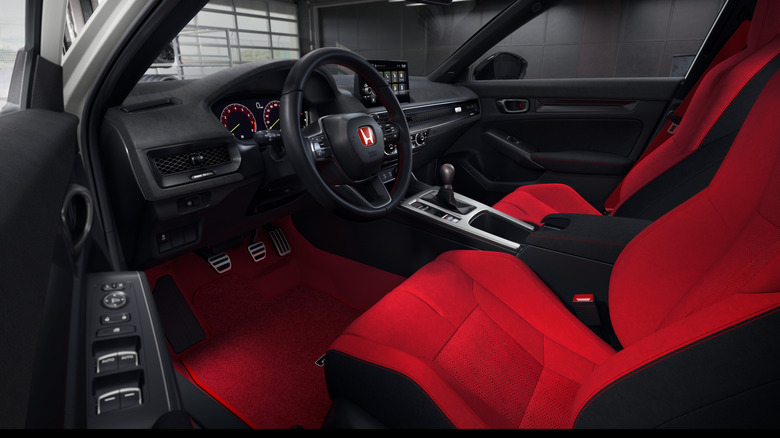 A look through the driver's door at the dash in the 2027 Civic Type R with its red seats and new Ultrasuede dash