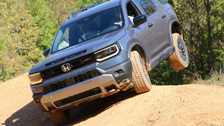 2027 Honda Passport TrailSport front 3/4 view off-roading at OEX in North Carolina