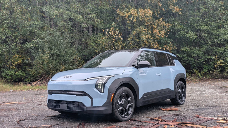 2027 Kia EV3 parked in front of trees
