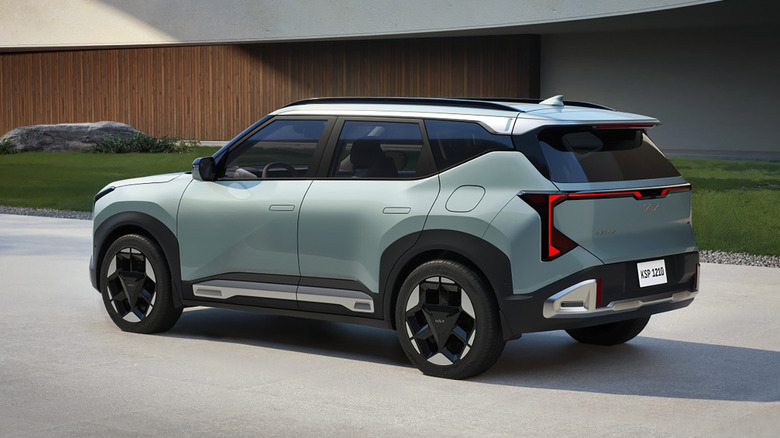 Rear 3/4 view of a light green 2027 Kia Seltos