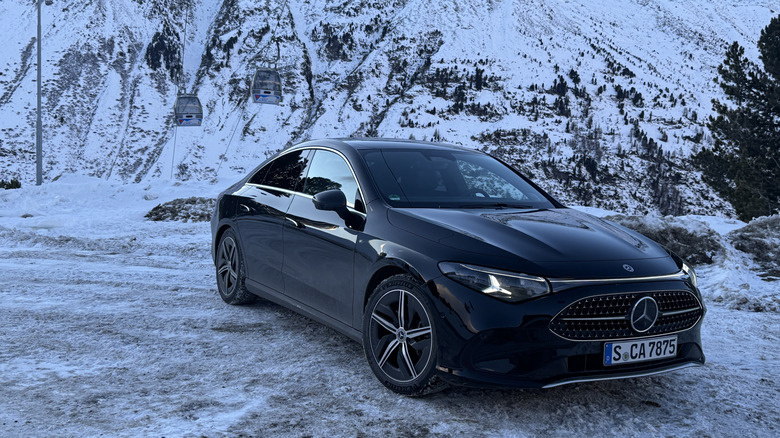Front 3/4 view of a black 2027 Mercedes-Benz CLA220 4Matic hybrid