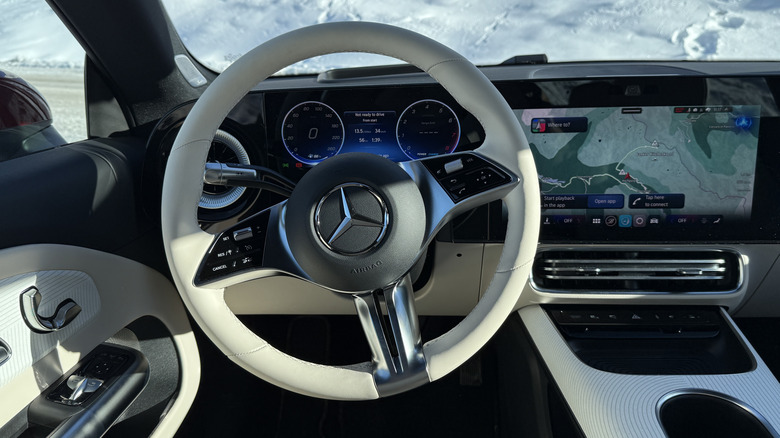 steering wheel view of a red 2027 Mercedes-Benz CLA220 4Matic hybrid