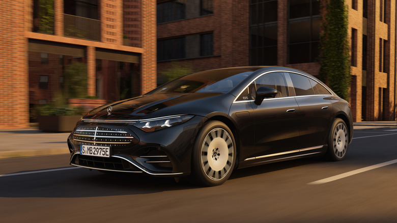 Front 3/4 view of a black 2027 Mercedes-Benz EQS sedan driving