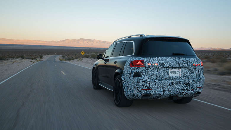 Rear 3/4 view of a camouflaged Mercedes-Benz GLS driving