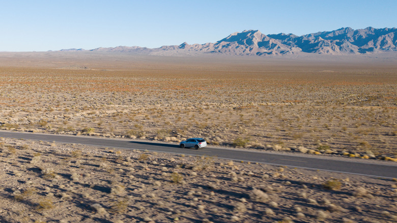 A camouflaged Mercedes-Benz GLE in the distance