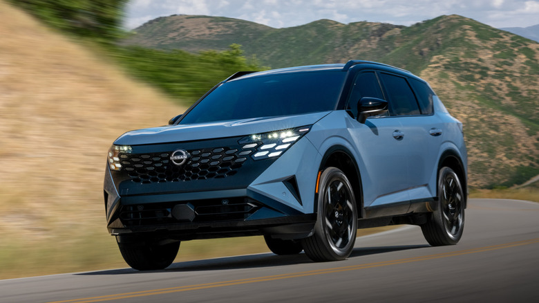 Front 3/4 view of a blue 2027 Nissan Rogue Hybrid