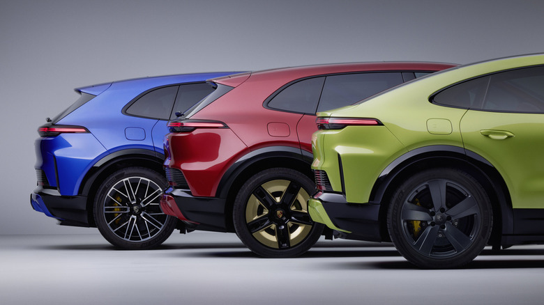 Rear ends of three brightly colored Porsche Cayenne Electrics