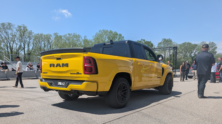 the 3/4ths back end view of a bright yellow Ram 1500 Rumble Bee SRT parked on the Chelsea Proving Grounds test track