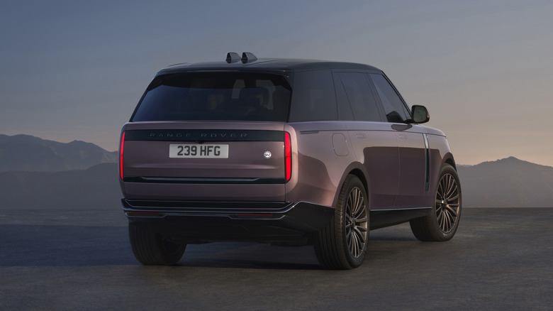 Rear 3/4 view of a pink 2027 Range Rover Electric