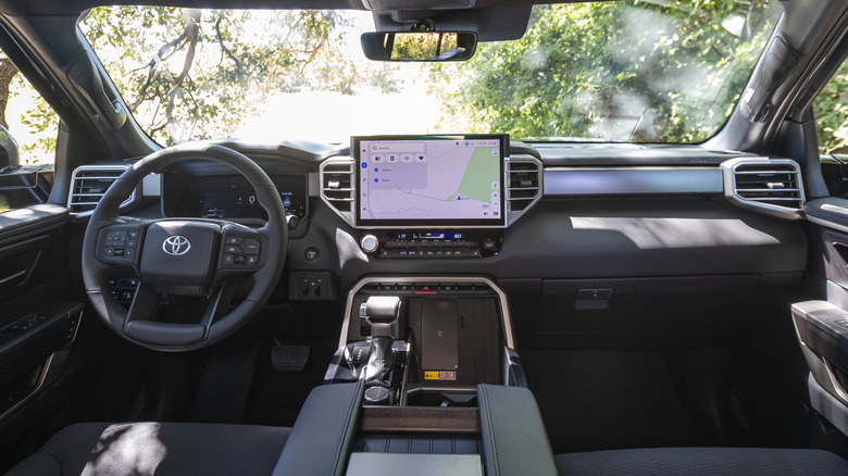 A wide shot of the 2027 Tundra's dashboard with trees visible out the windshield