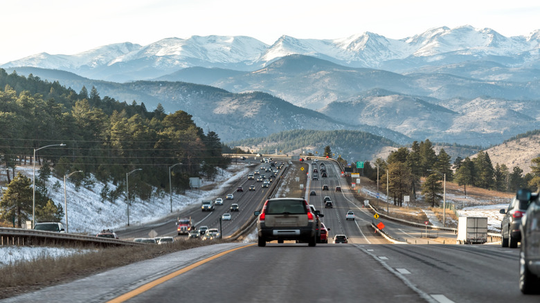 Colorado Interstate 70 road in Denver Golden with exit sign and traffic jam from snow capped mountains ski season
