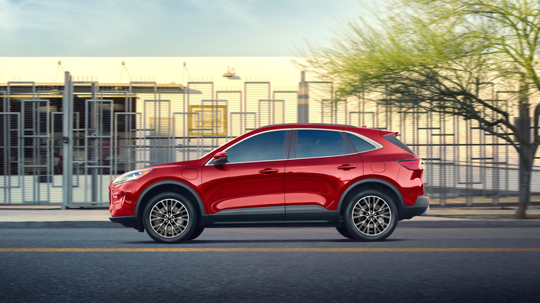 A red 2020 Ford Escape plug-in hybrid is viewed from the side.