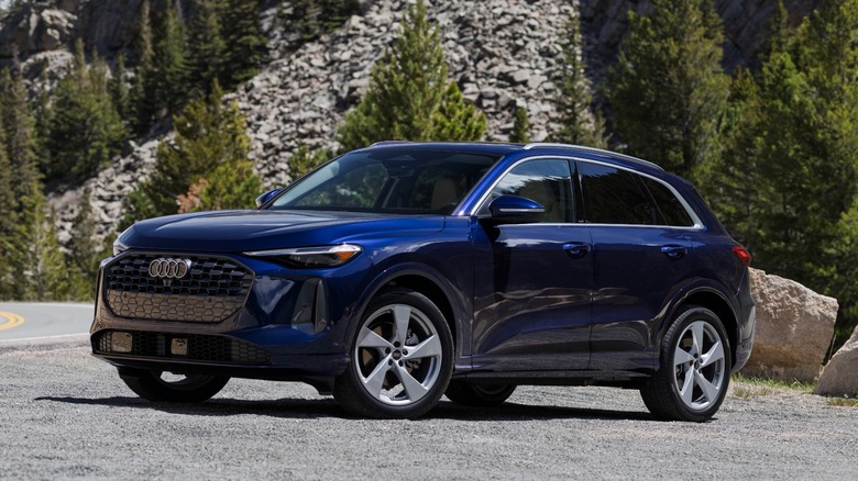 An Audi Q5 in blue parked on the side of the road