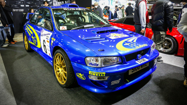 A blue Subaru WRX STi with gold rims at the Tokyo Auto Salon in 2025