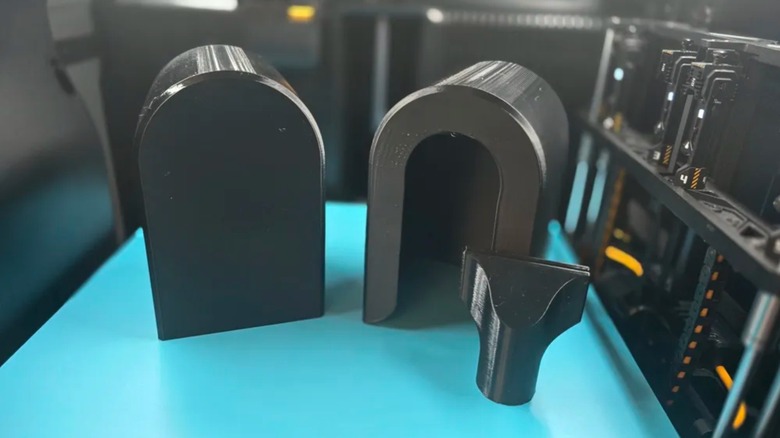 A Flock camera cover disassembled on a blue table