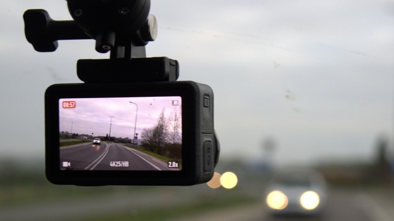 A dashcam mounted to a windshield recording a drive