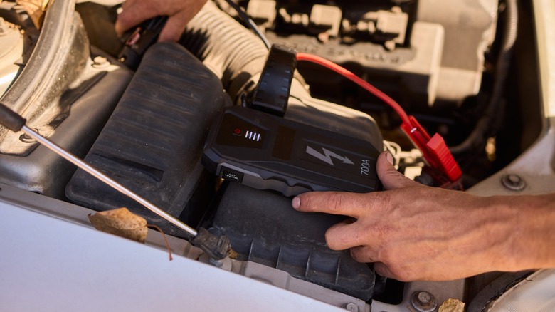Portable jump starter connected to a car battery