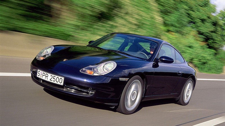 A front left 3/4 of a dark blue 2001 Porsche 911 in motion.