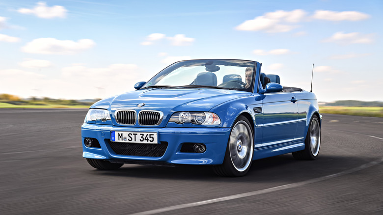 A front left 3/4 of a blue E46 BMW M3 Convertible in motion.
