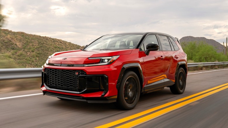 A front left 3/4 view of a red 2026 Toyota RAV4 GR Sport on the road