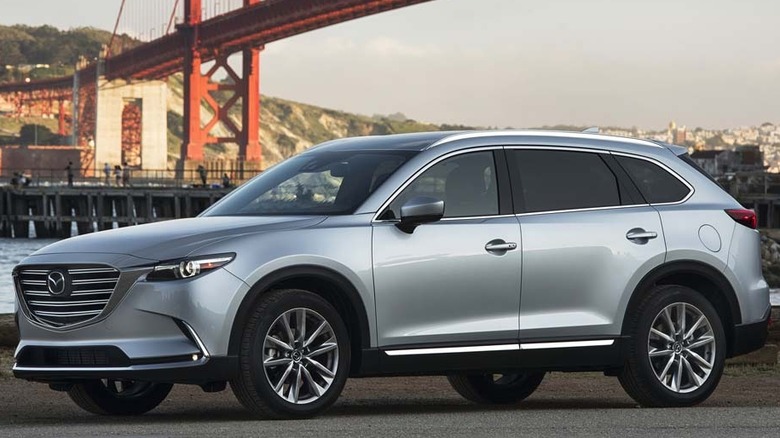A Mazda CX-9 sits parked near water.