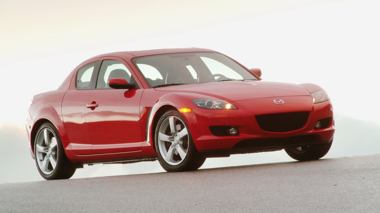 A red Mazda RX-8 sits parked.