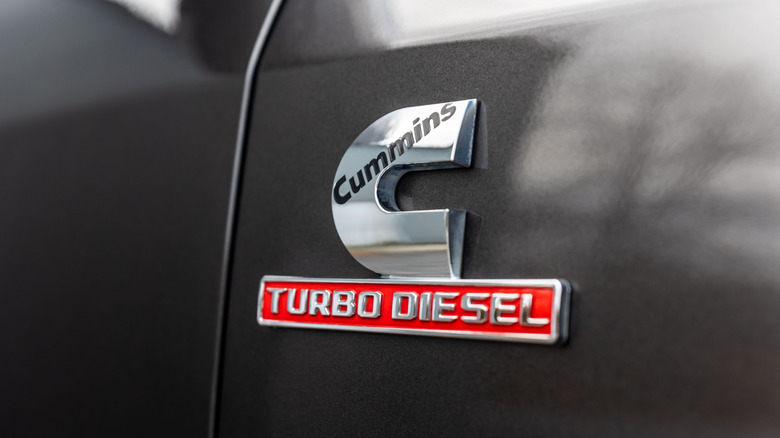 A close-up of a gray RAM truck with a C Turbo Diesel badge on its fender.