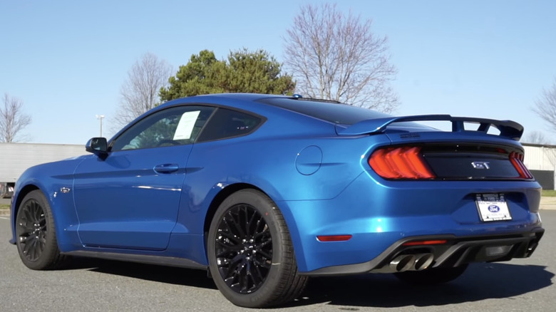 A blue 2020 Ford Mustang is parked in a lot.