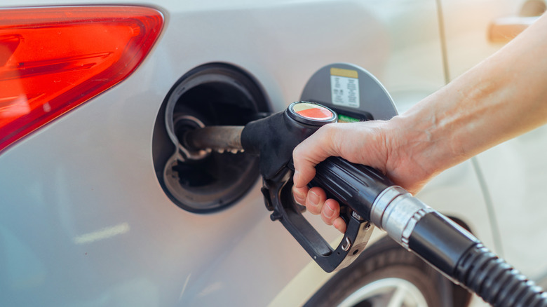 Hand of person filling up a car's gas tank