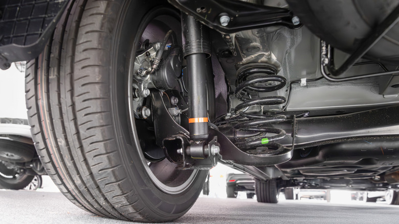 A close-up view of one side of a car's suspension assembly.
