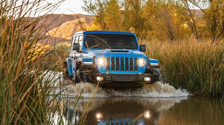 A Jeep Wrangler wading through water.