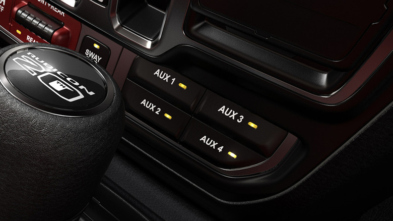 Backlit AUX switches on a Jeep Wrangler.