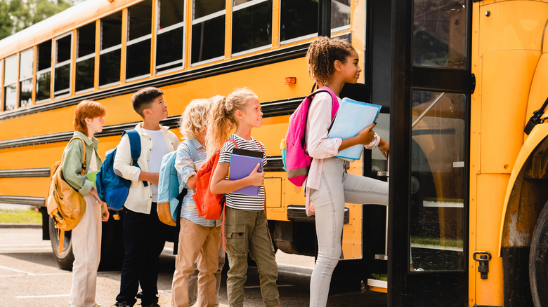 Kids getting on a school bus