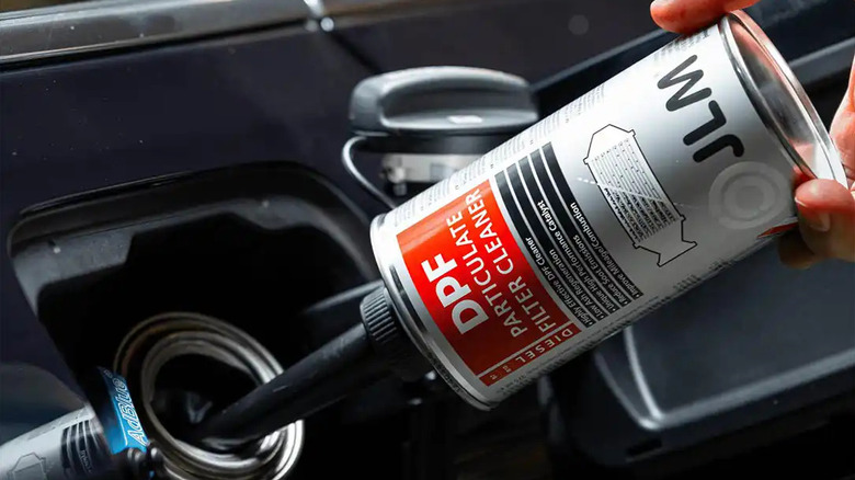 JLM dpf cleaner being poured into gas tank