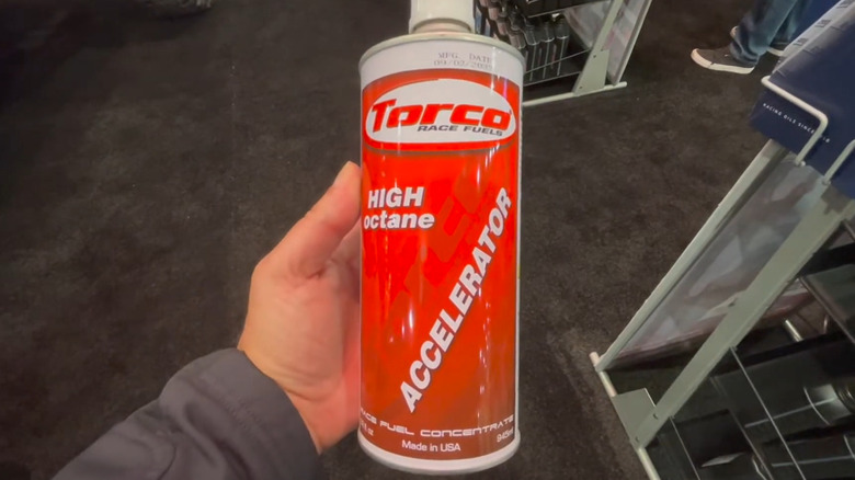 Man holding Torco Unleaded Accelerator