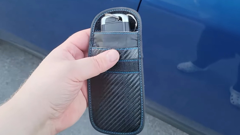 Person holding Faraday bag for their key fob