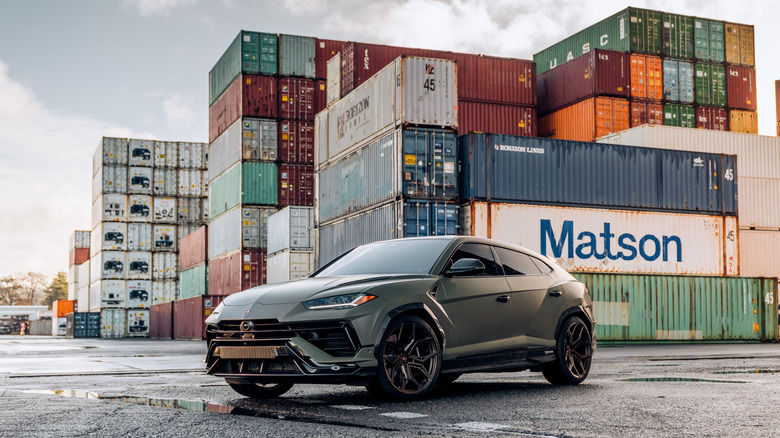 Lamborghini Urus in front of shipping containers
