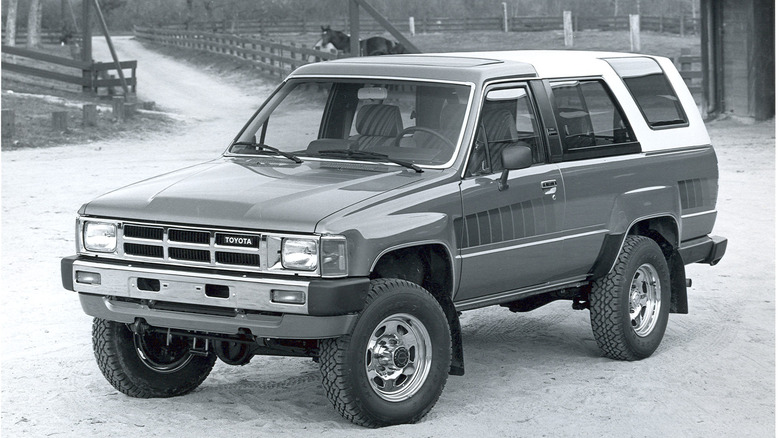 A black-and-white photo of a first-generation Toyota 4Runner with a removable rear section.