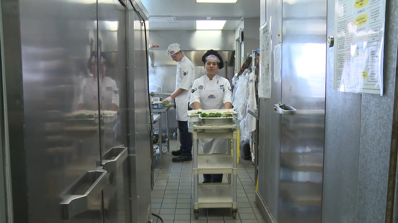 A chef preparing food in a galley aboard Air Force One.