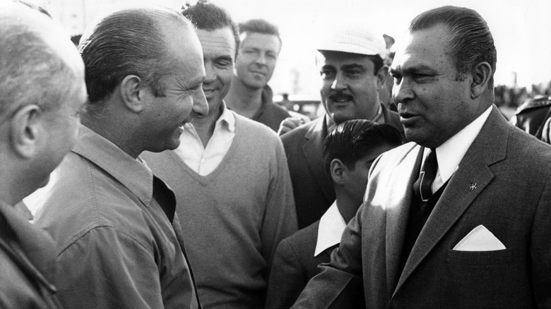 Juan Manuel Fangio (left) shaking hands with Cuban dictator Fulgencio Batista in 1958