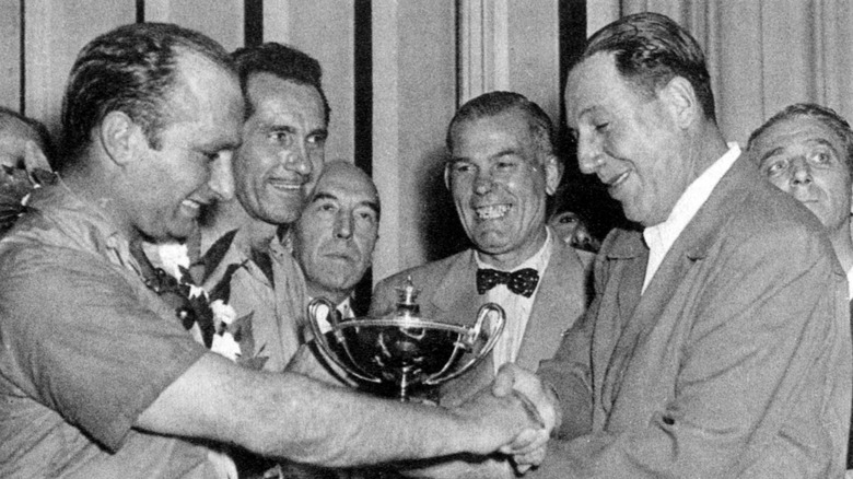 Juan Manuel Fangio (left) shakes hands with President of Argentina Juan Domingo Perón after winning the F1 Grand Prix of Argentina on January 16, 1955 in Buenos Aires Argentina