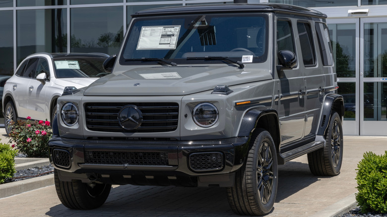 A brand-new gray Mercedes-Benz G 580 with EQ Technology parked in front of a dealer.